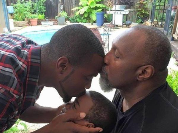 Three generations of men — grandfather, father and son — share a moment poolside