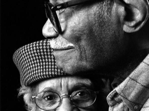 A dignified elderly couple in a black-and-white portrait