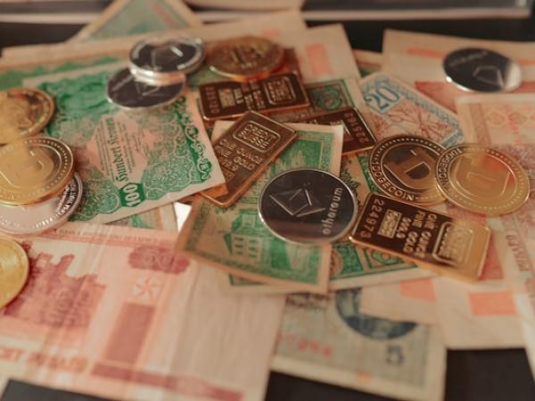 Banknotes of several currencies arranged on a table.